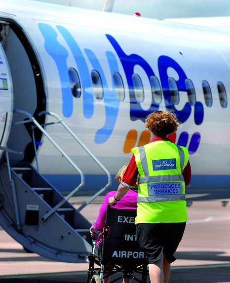 Disabled person being escorted to a Flybe plane